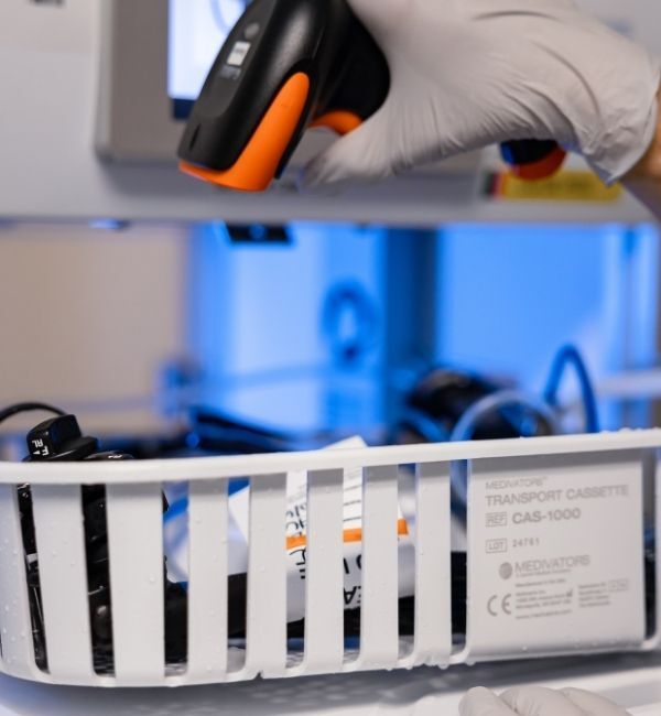 Technician scanning an endoscope to track workflow steps and confirm processing requirements